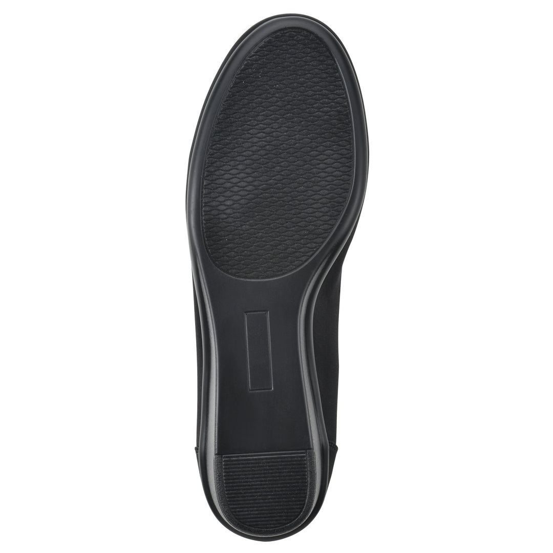 Sole view of a low, black, fabric wedge with black sole