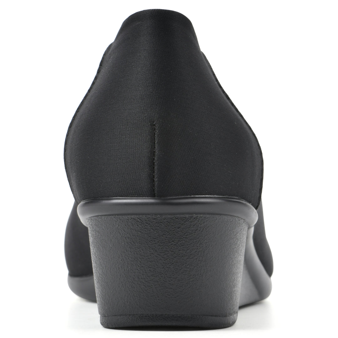 Rear view of a low, black, fabric wedge with black sole