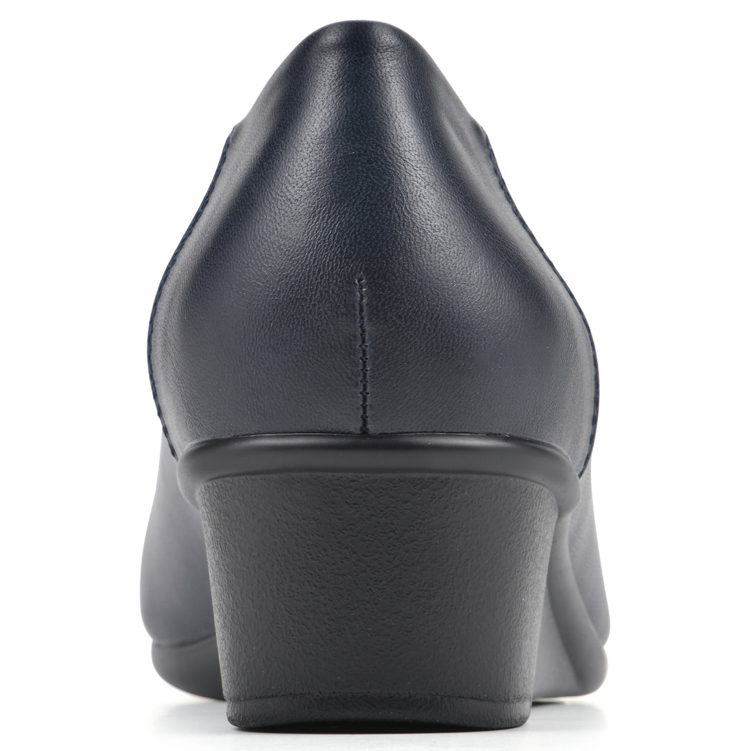 Rear view of a low, navy, faux leather wedge with black sole
