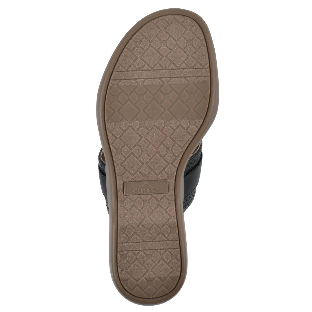 Sole view of a black thong sandal with a centered metal ring ornament and tan sole