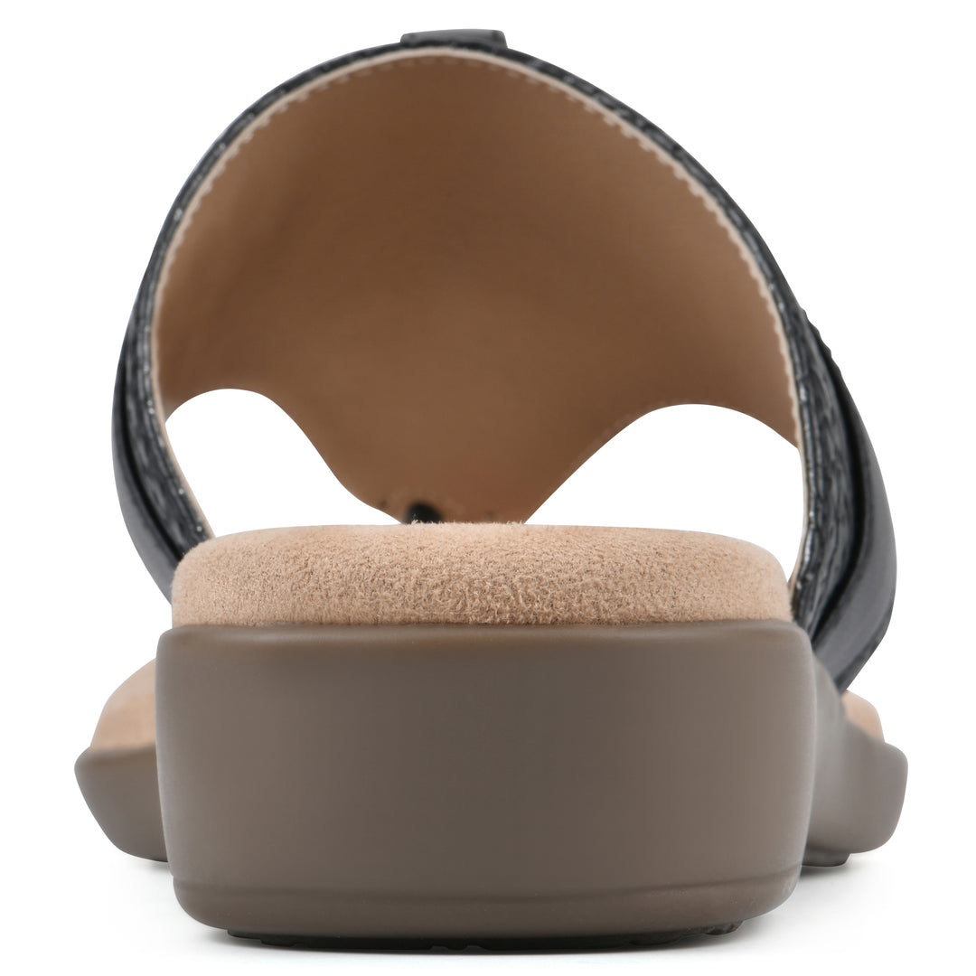 Rear view of a black thong sandal with a centered metal ring ornament and tan sole