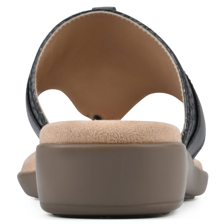Rear view of a black thong sandal with a centered metal ring ornament and tan sole