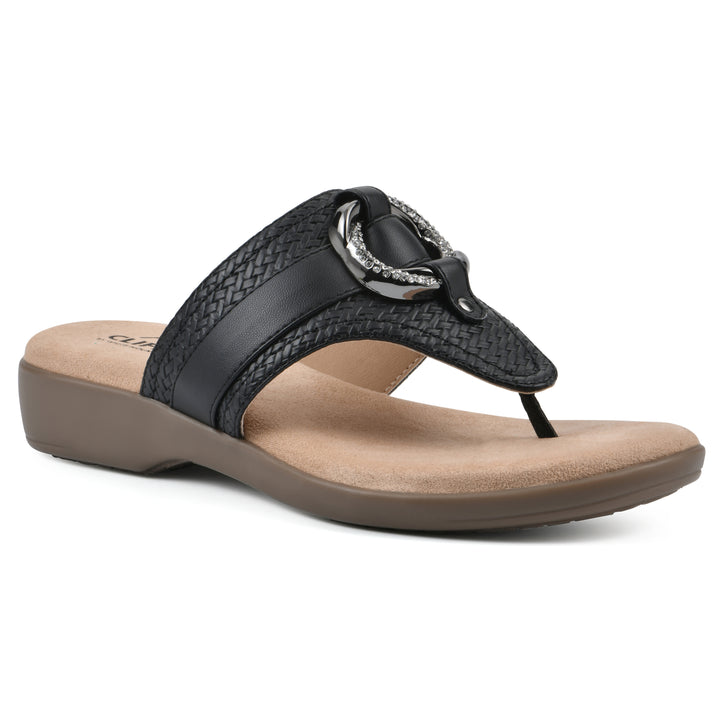 Angle view of a black thong sandal with a centered metal ring ornament and tan sole