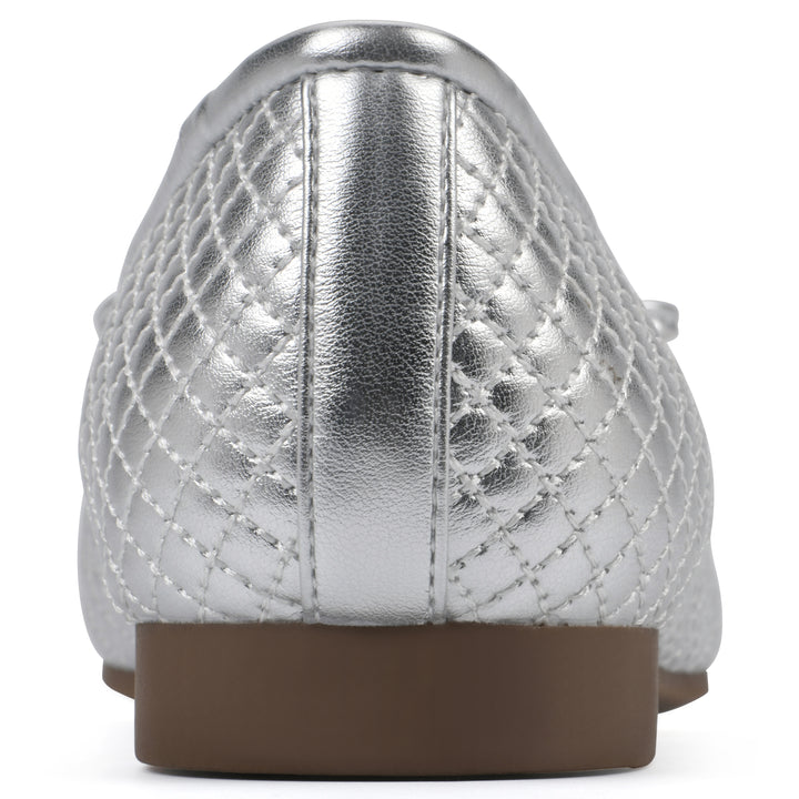 Rear view of a silver quilted pattern flat with small, centered, silver bow and a brown sole