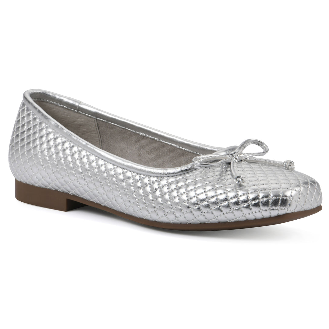 Angle view of a silver quilted pattern flat with small, centered, silver bow and a brown sole