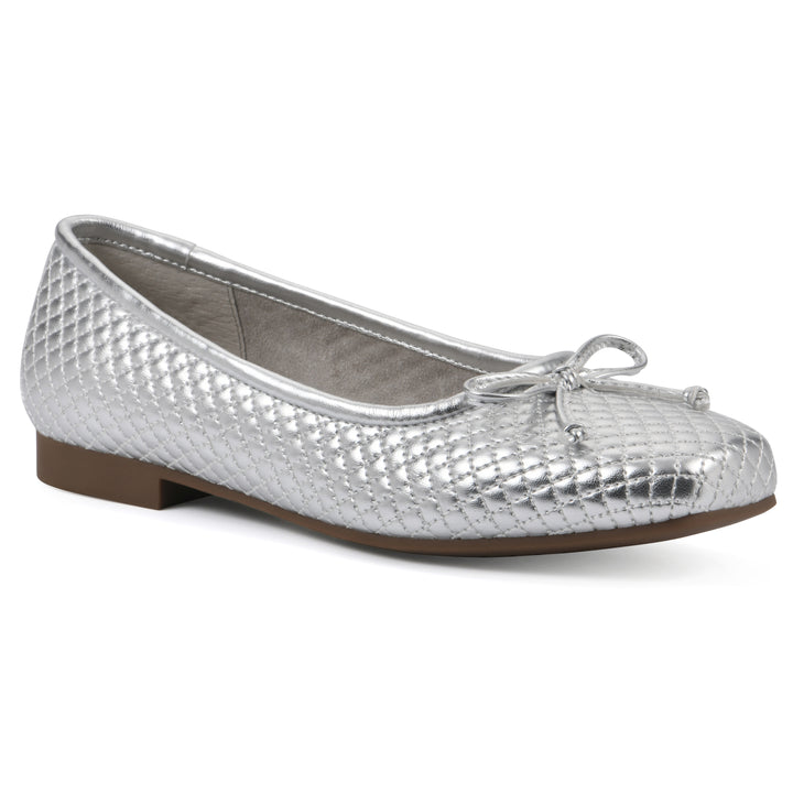 Angle view of a silver quilted pattern flat with small, centered, silver bow and a brown sole