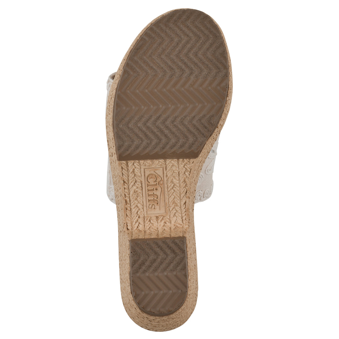 Sole view of an ivory wedge sandal with cream embroidered floral pattern and a braided rope-style sole
