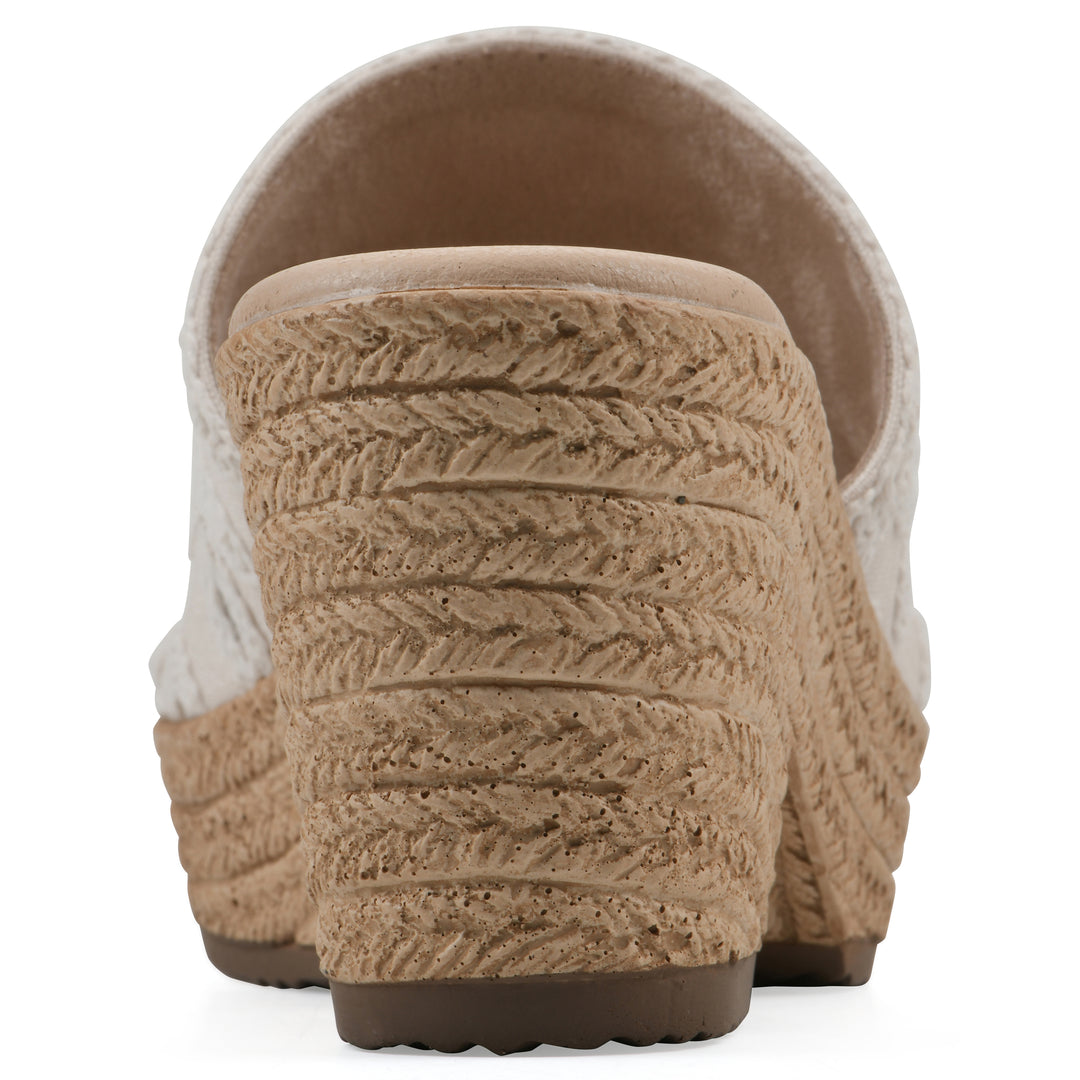 Rear view of an ivory wedge sandal with cream embroidered floral pattern and a braided rope-style sole