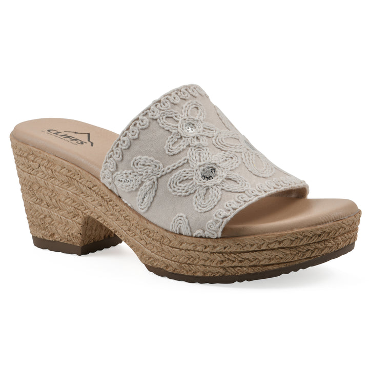 Angle view of an ivory wedge sandal with cream embroidered floral pattern and a braided rope-style sole