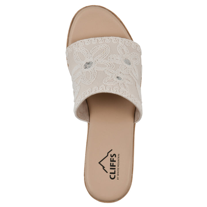 Top view of an ivory wedge sandal with cream embroidered floral pattern and a braided rope-style sole
