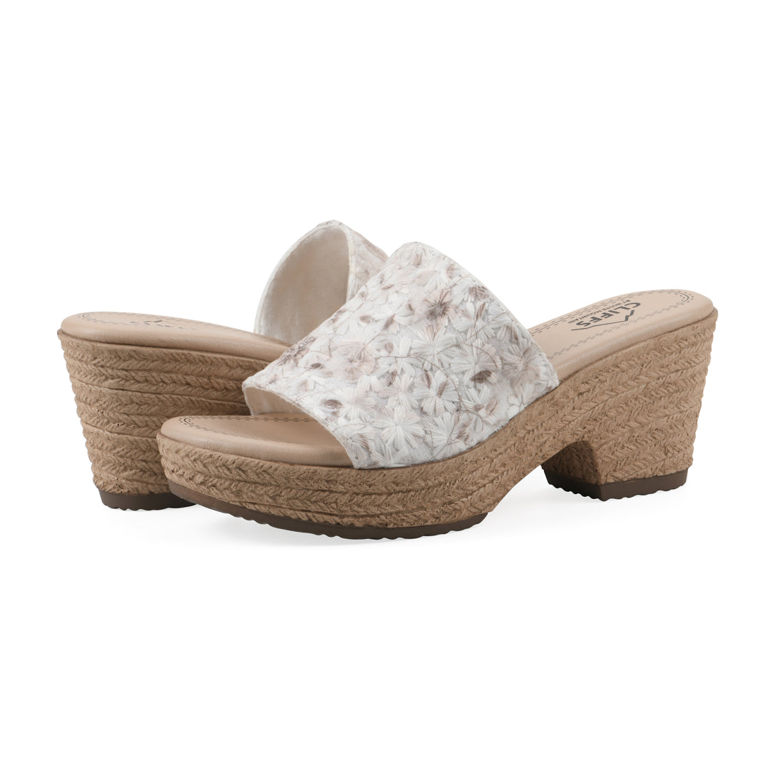 Angle view of a pair of soft white floral designed wedge sandals with a braided rope-style sole