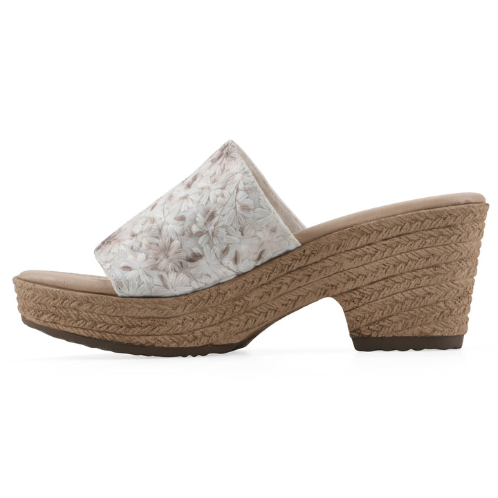 Side view of a soft white floral designed wedge sandal with a braided rope-style sole