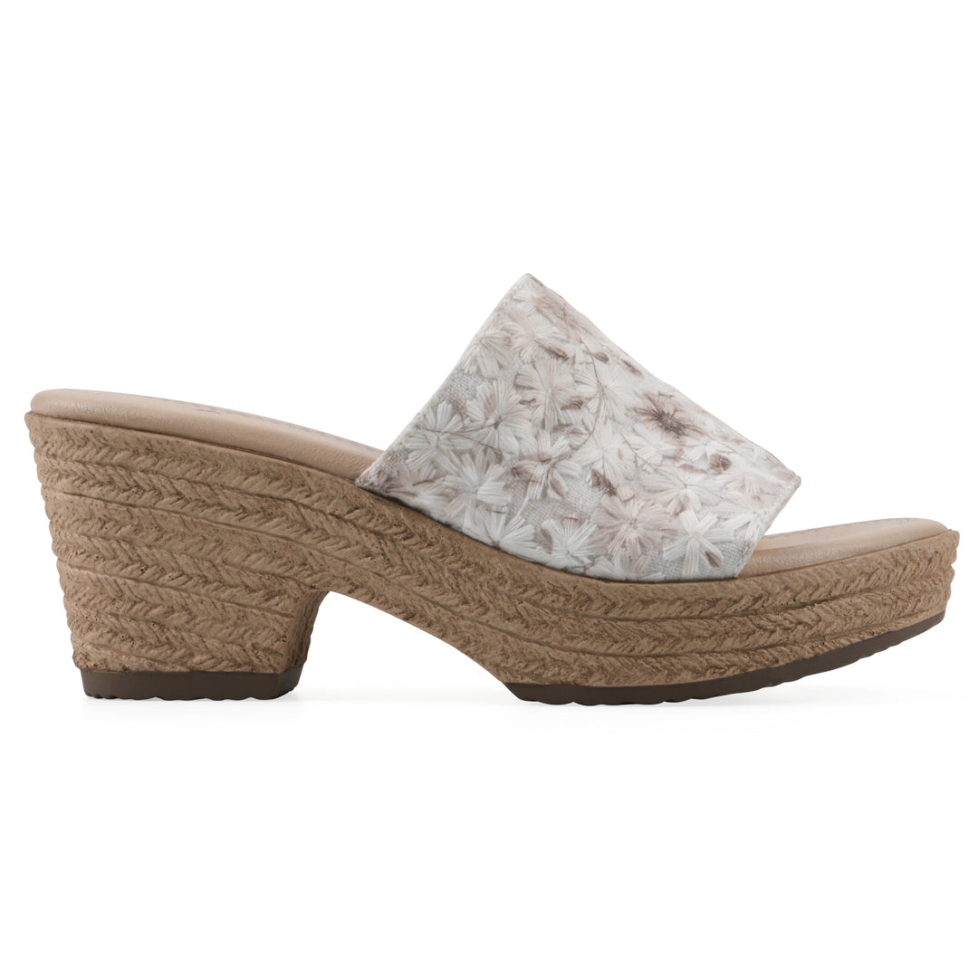 Side view of a soft white floral designed wedge sandal with a braided rope-style sole