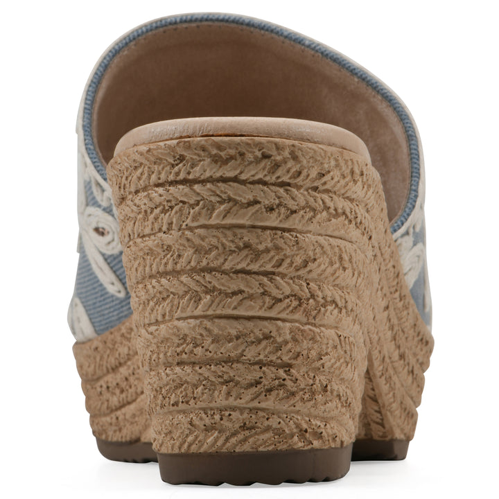 Rear view of a denim wedge sandal with cream embroidered floral pattern and a braided rope-style sole