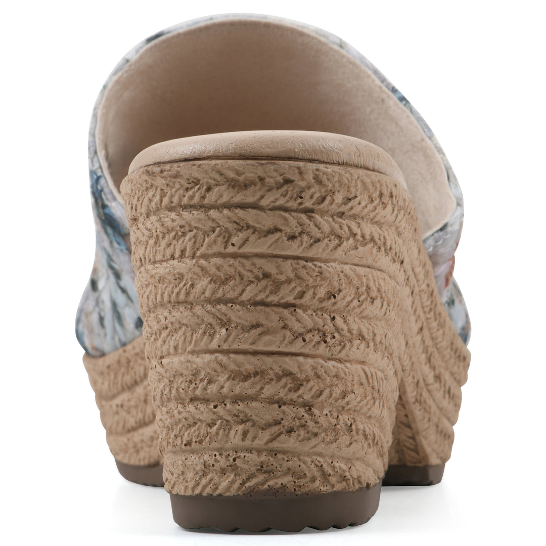 Rear view of a muted watercolor floral pattern wedge sandal and a braided rope-style sole