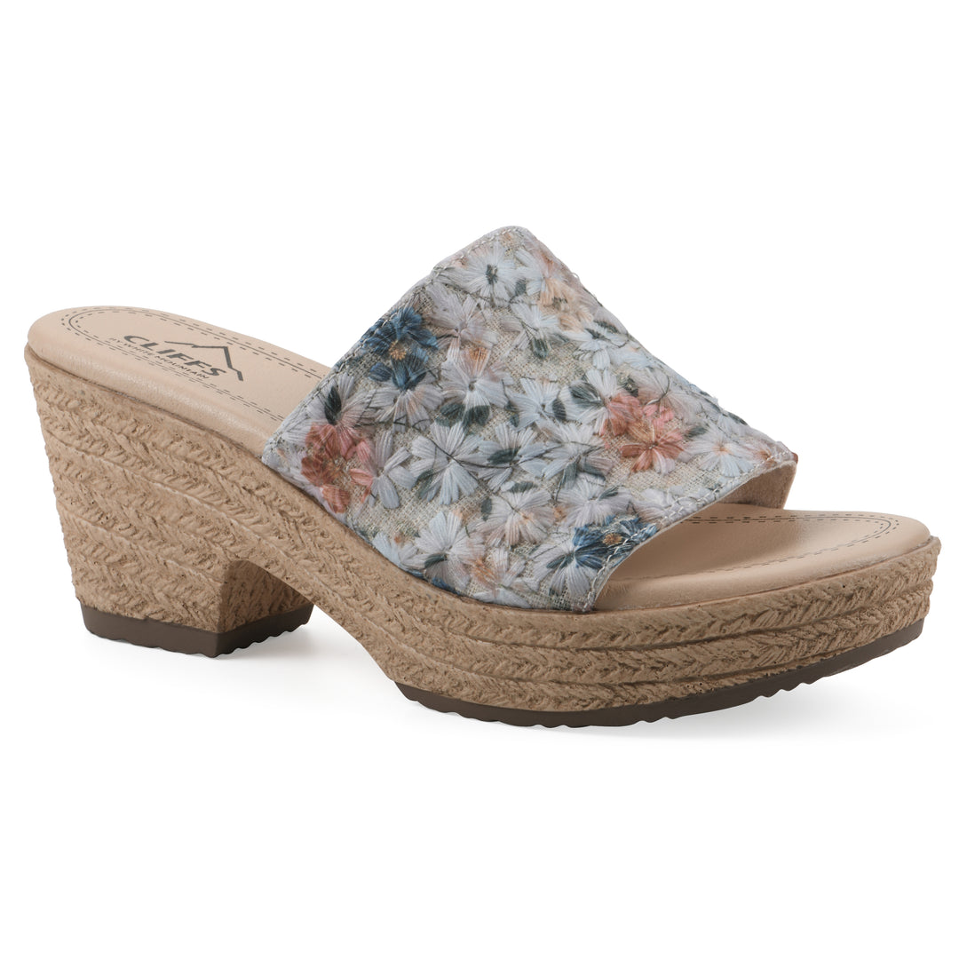 Angle view of a muted watercolor floral pattern wedge sandal and a braided rope-style sole