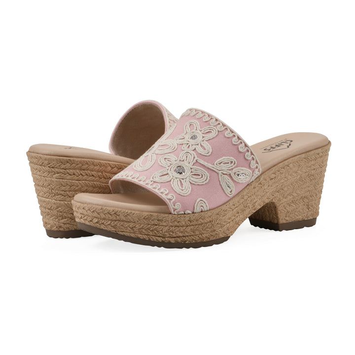 Angle view of a pair of pale pink wedge sandals with cream embroidered floral pattern and a braided rope-style sole