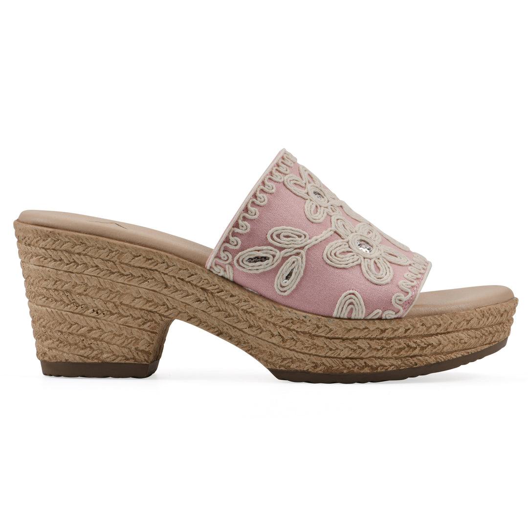 Side view of a pale pink wedge sandal with cream embroidered floral pattern and a braided rope-style sole