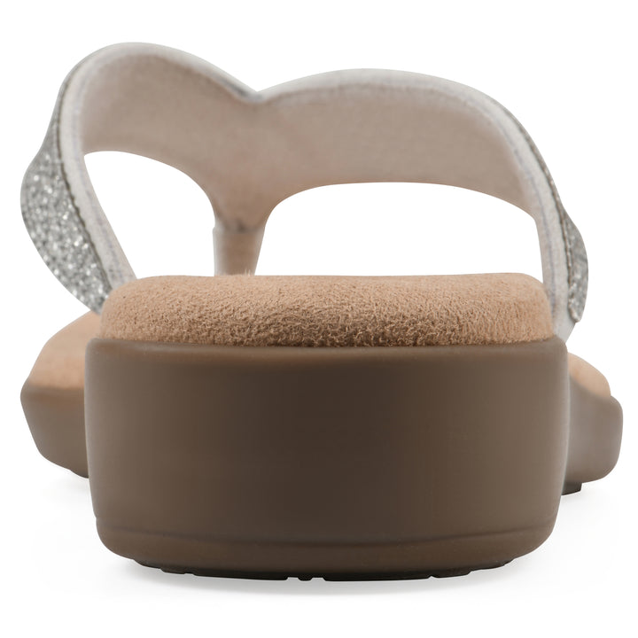 Rear view of a cushioned thong sandal with low-sheen textured ecru straps and a tan sole 