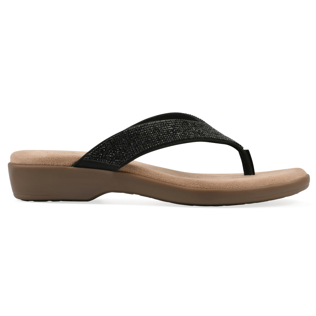 Side view of a cushioned thong sandal with low-sheen textured black straps and a tan sole 