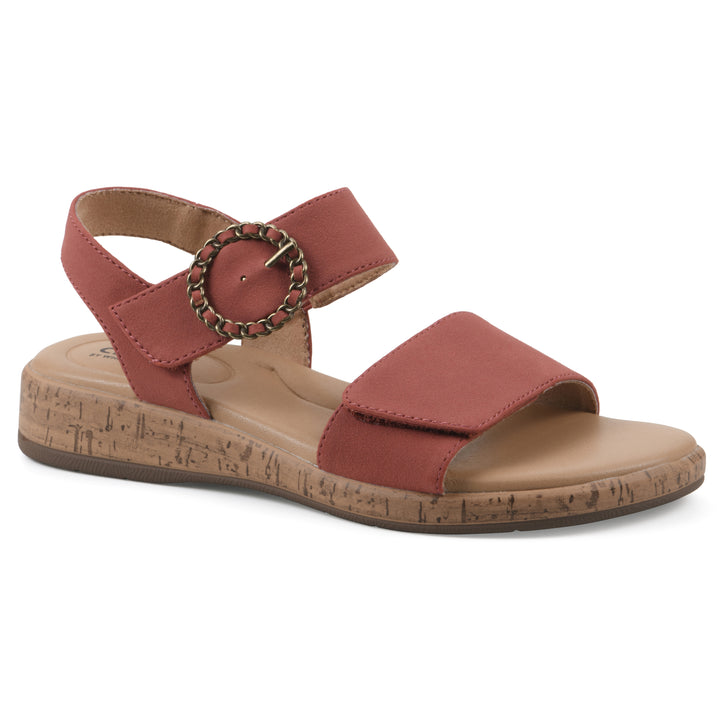 Angle view of a dusty orange sandal with double adjustable straps, circular buckle embellishment, and low cork print wedge 