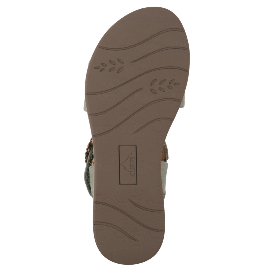 Sole view of a sage sandal with double adjustable straps, circular buckle embellishment, and low cork print wedge 
