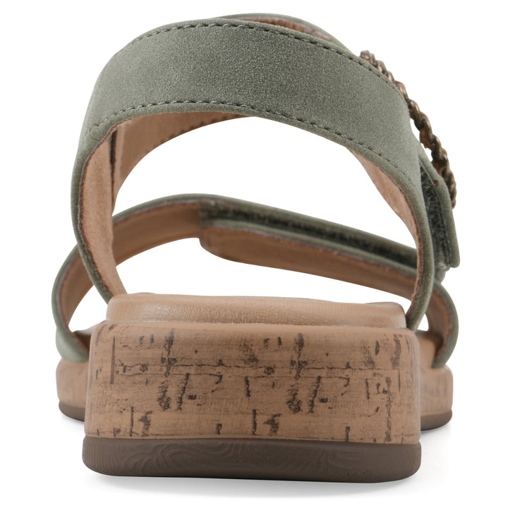 Rear view of a sage sandal with double adjustable straps, circular buckle embellishment, and low cork print wedge 