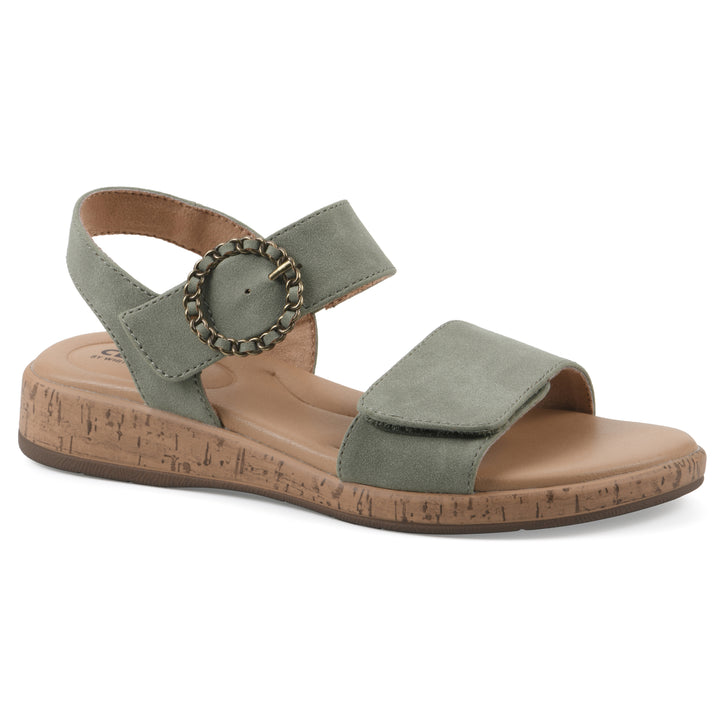 Angle view of a sage sandal with double adjustable straps, circular buckle embellishment, and low cork print wedge 