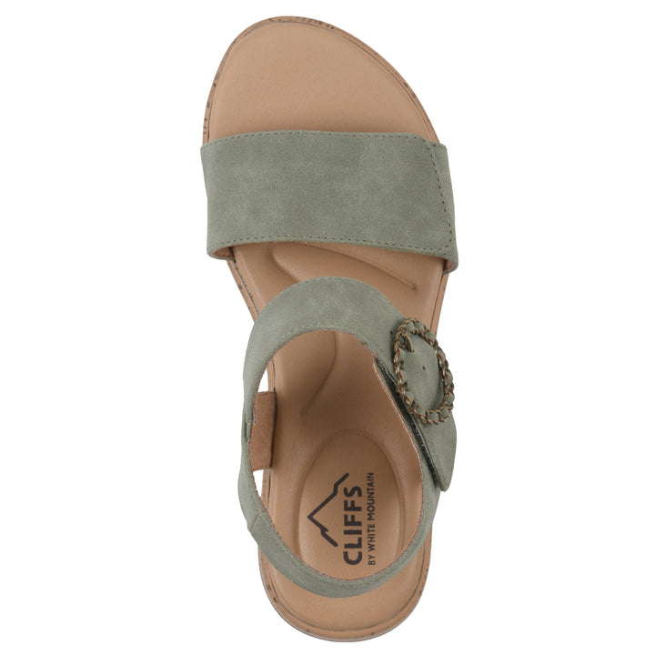 Top view of a sage sandal with double adjustable straps, circular buckle embellishment, and low cork print wedge 