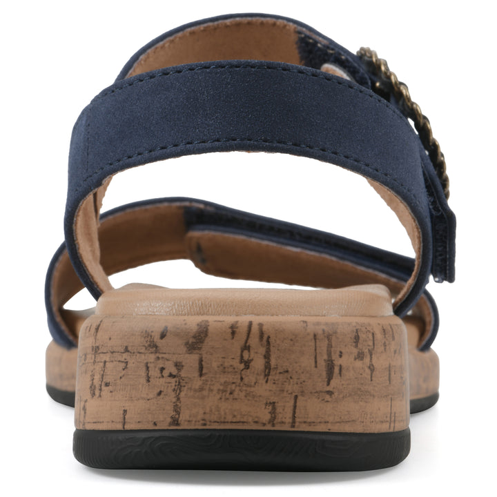 Rear view of a dark blue sandal with double adjustable straps, circular buckle embellishment, and low cork print wedge 