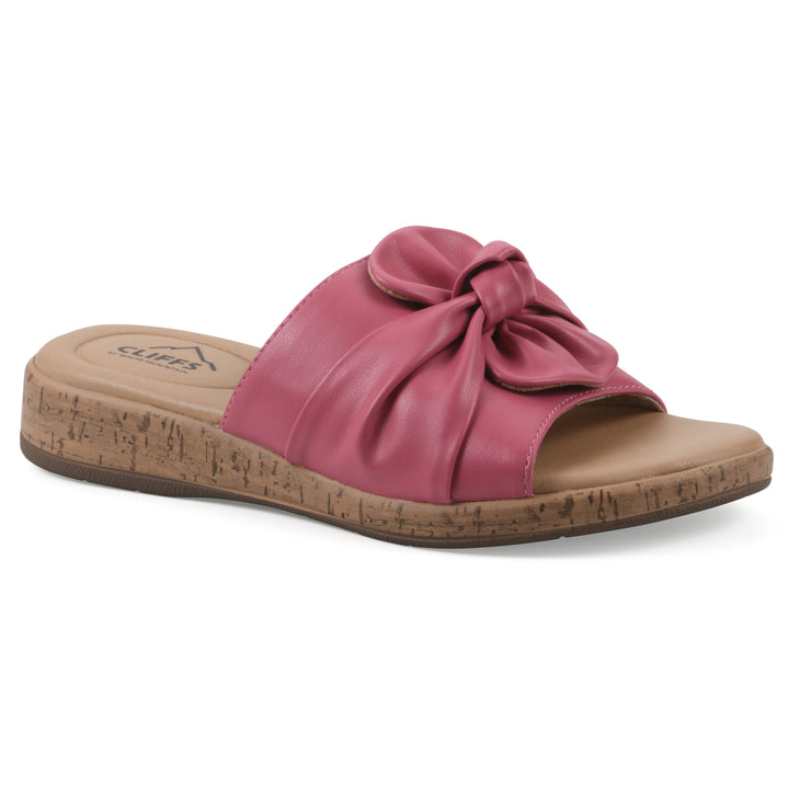 Angle view of a mauve faux leather sandal with centered twist, and cork-print sole design