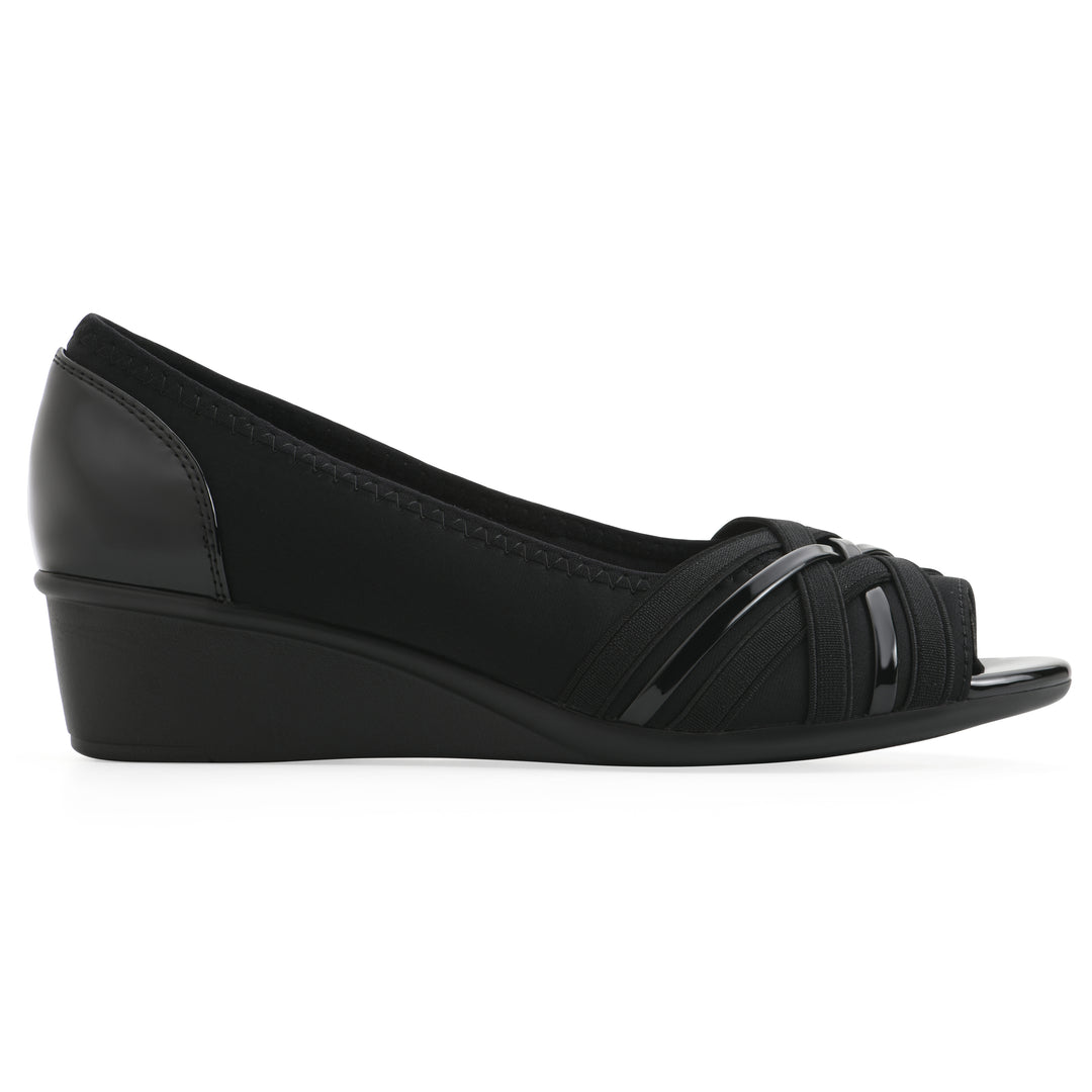 Side view of slip-on black wedge with a peep toe