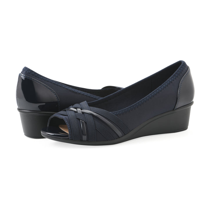 Angle view of a pair of slip-on navy wedges with a peep toe