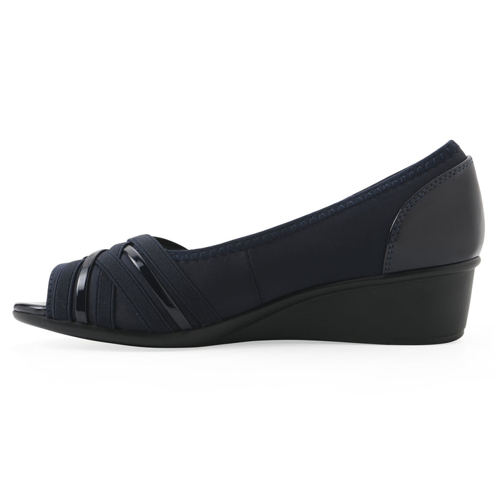 Side view of slip-on navy wedge with a peep toe