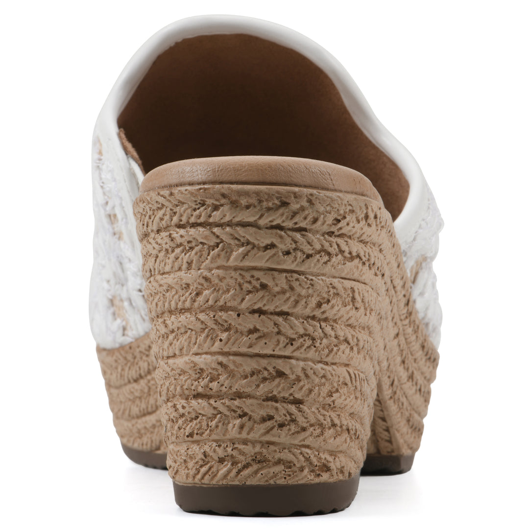 Rear view of a white and natural raffia embroidered fabric wedge sandal with a braided rope-style sole