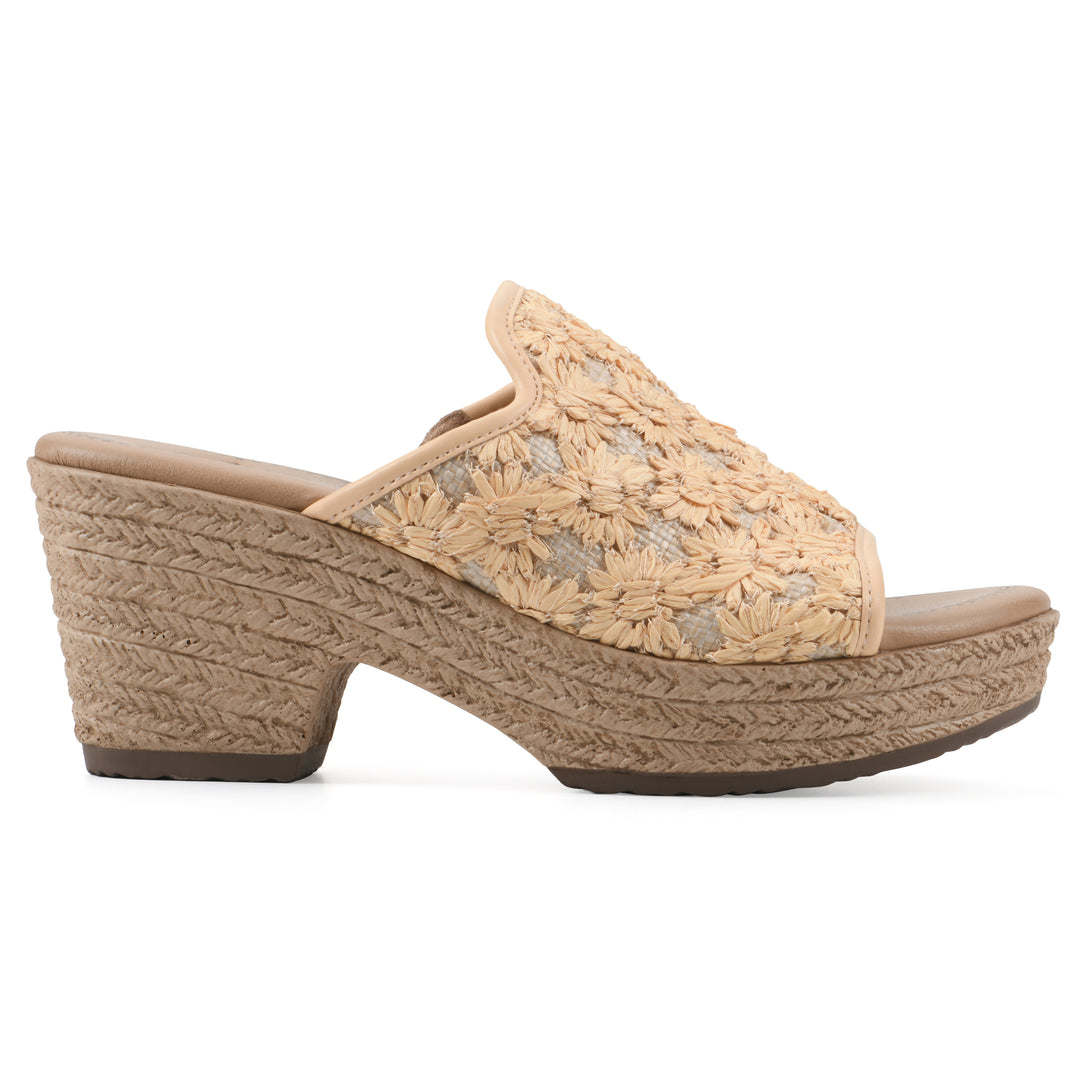 Side view of a light mustard embroidered fabric wedge sandal with a braided rope-style sole