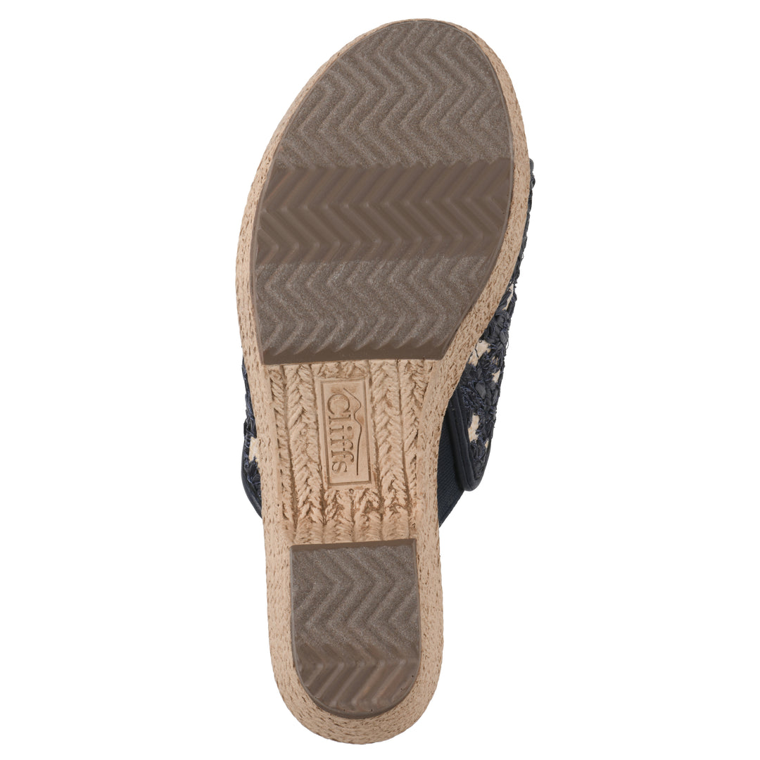 Sole view of a dark blue embroidered fabric wedge sandal with a braided rope-style sole