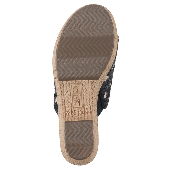 Sole view of a dark blue embroidered fabric wedge sandal with a braided rope-style sole