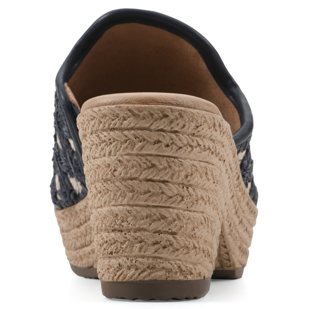 Rear view of a dark blue embroidered fabric wedge sandal with a braided rope-style sole