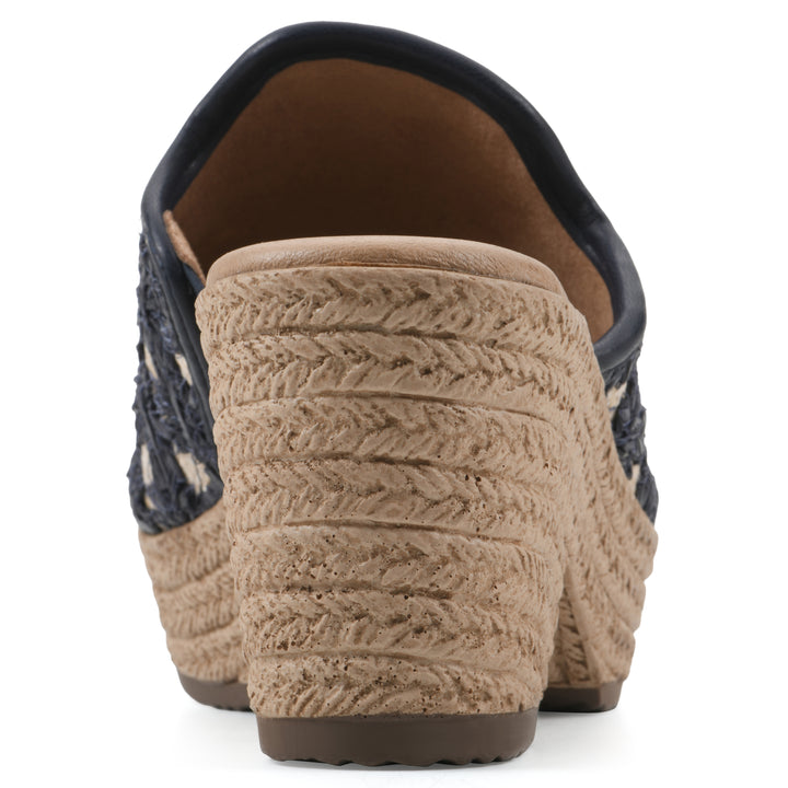 Rear view of a dark blue embroidered fabric wedge sandal with a braided rope-style sole