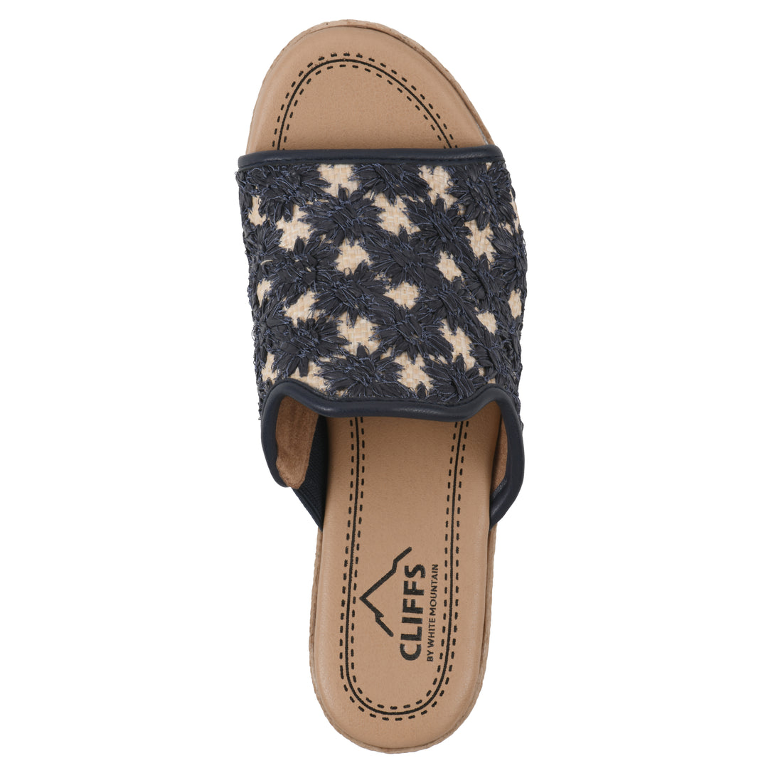 Top view of a dark blue embroidered fabric wedge sandal with a braided rope-style sole