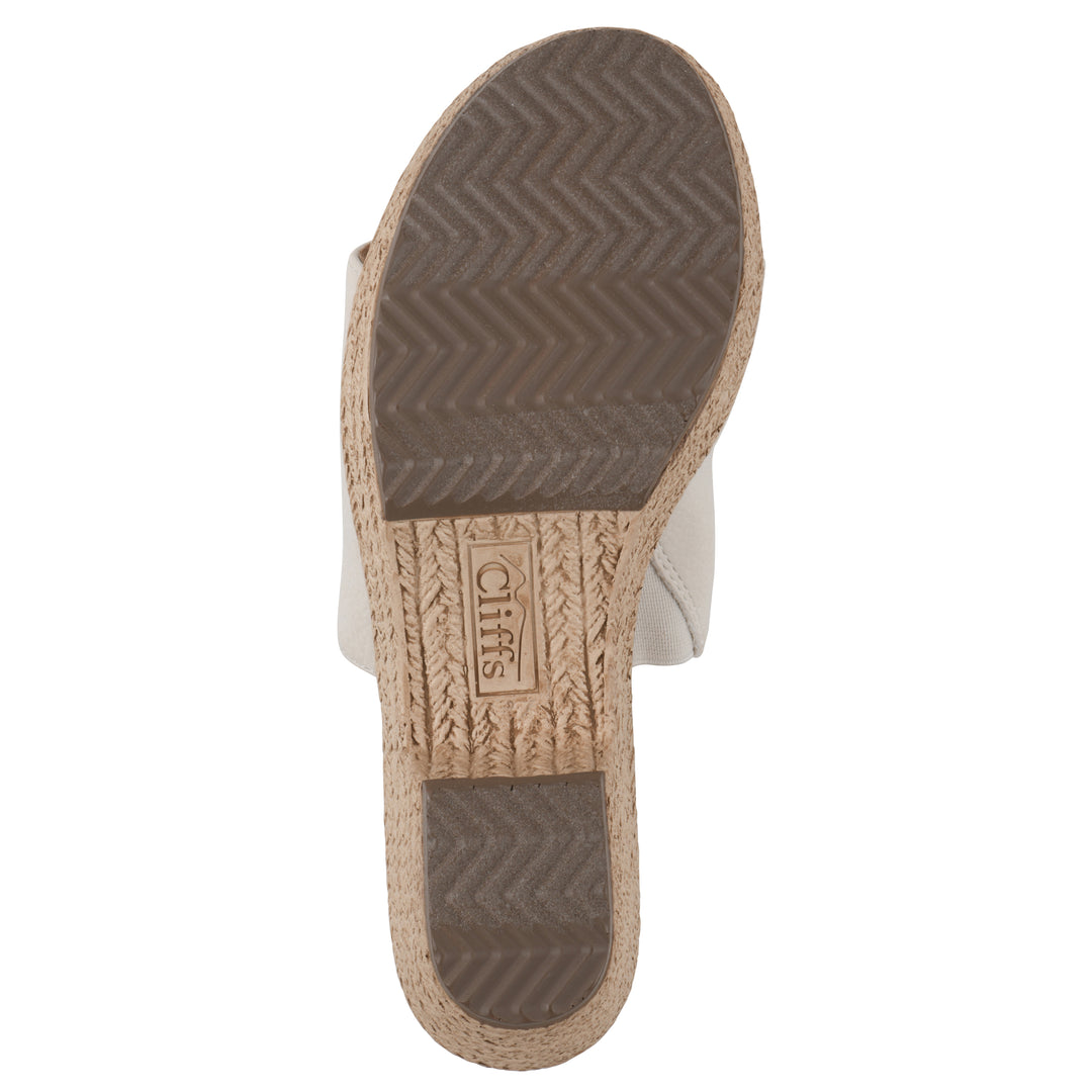 Sole view of a cream, backless wedge sandal with centered sunflower embellishment, and braided rope style heel