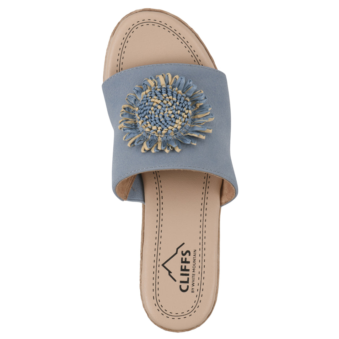 Top view of a blue, backless wedge sandal with centered sunflower embellishment, and braided rope style heel