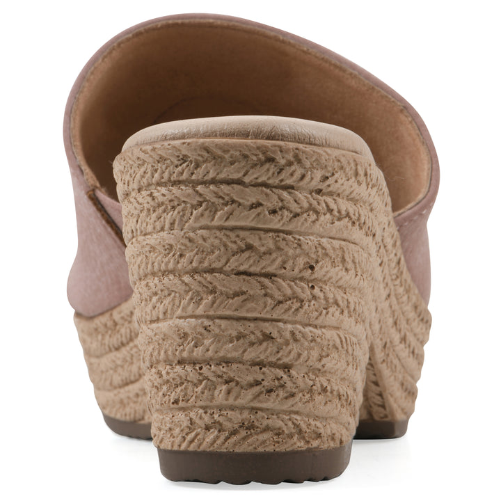 Rear view of a taupe, backless wedge sandal with centered sunflower embellishment, and braided rope style heel