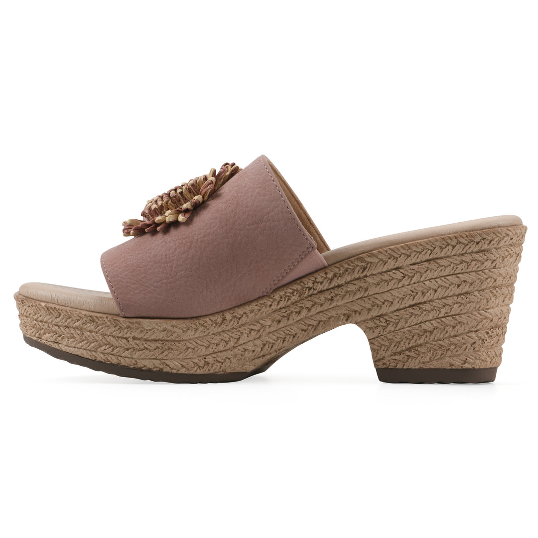 Side view of a taupe, backless wedge sandal with centered sunflower embellishment, and braided rope style heel