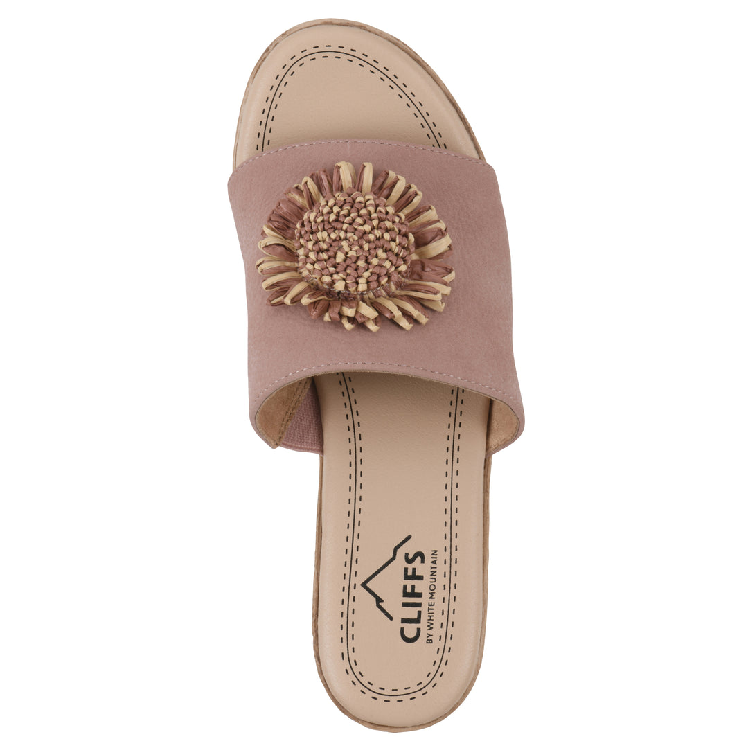 Top view of a taupe, backless wedge sandal with centered sunflower embellishment, and braided rope style heel