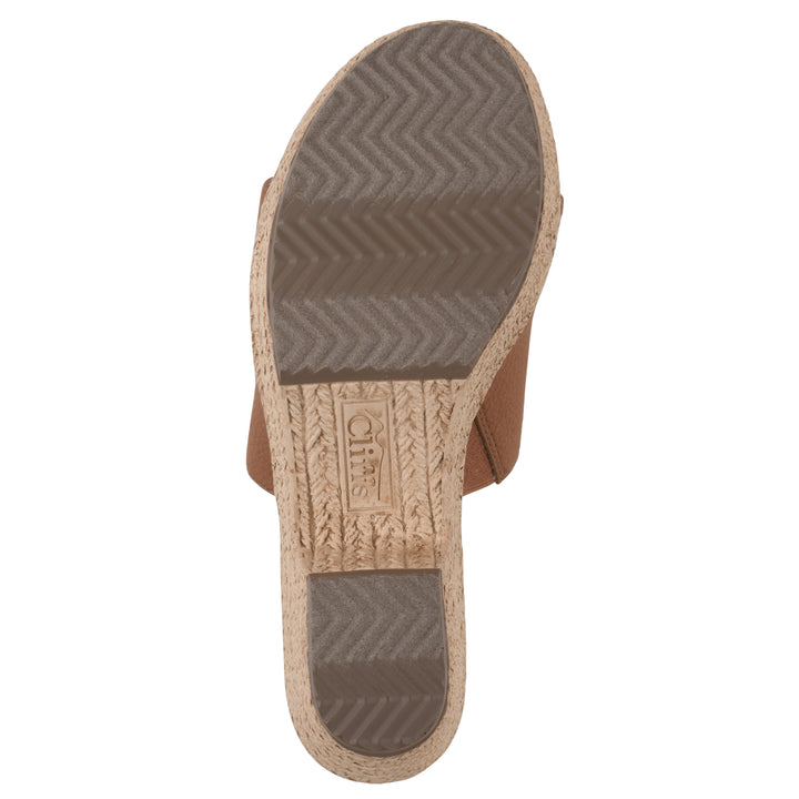 Sole view of a brown, backless wedge sandal with centered sunflower embellishment, and braided rope style heel
