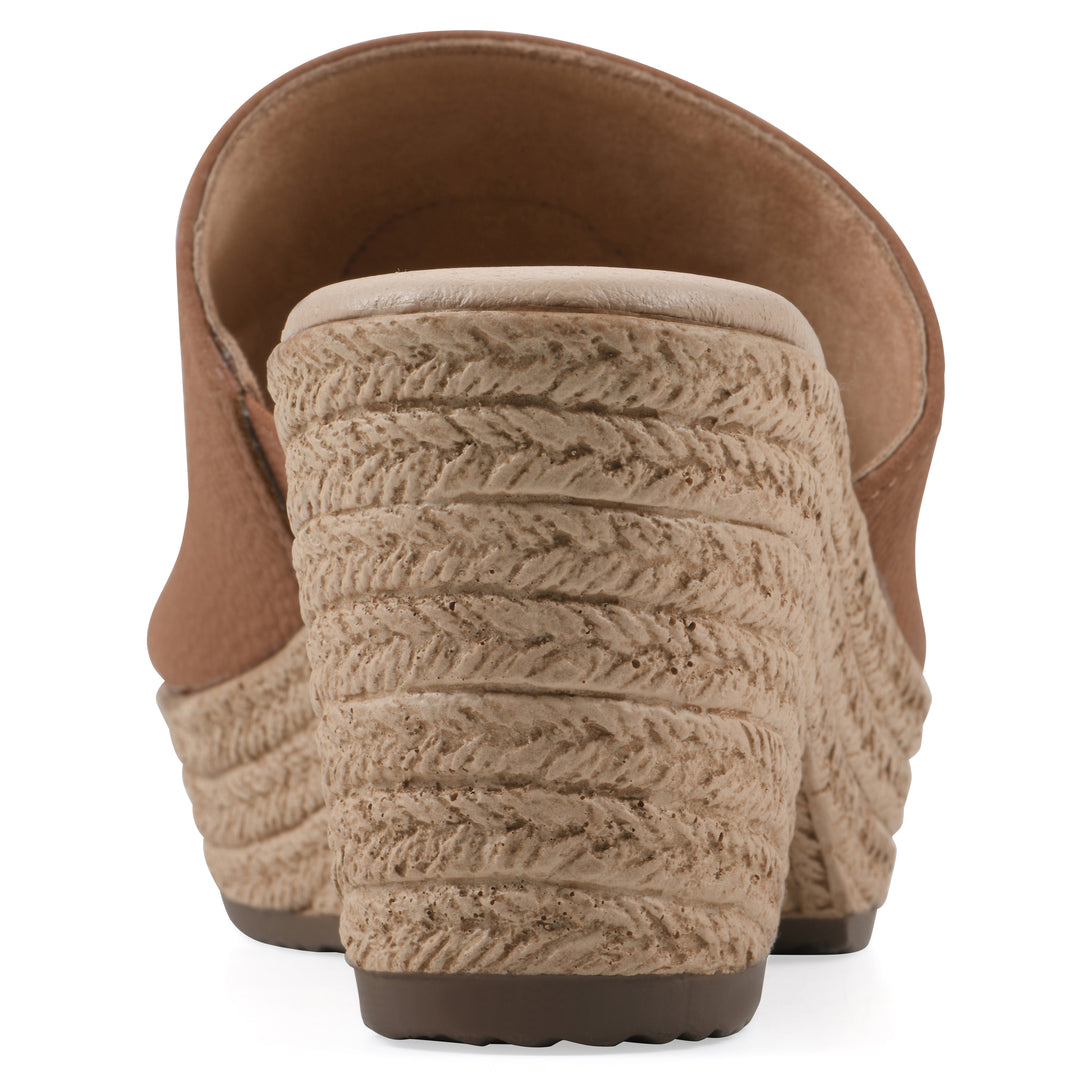 Rear view of a brown, backless wedge sandal with centered sunflower embellishment, and braided rope style heel