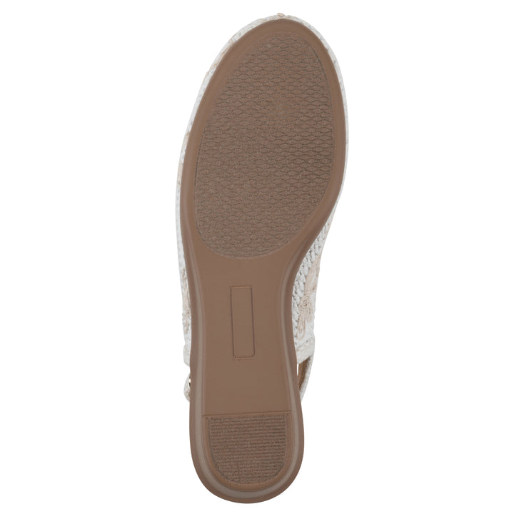 Sole view of a woven, white, raffia slingback with white floral detailing and an adjustable heel strap