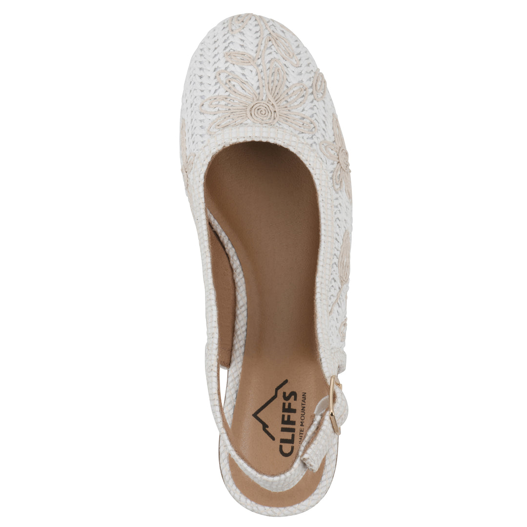 Top view of a woven, white, raffia slingback with white floral detailing and an adjustable heel strap